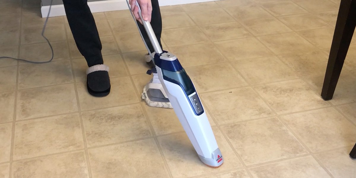 Person using Bissell PowerFresh Deluxe attachment to clean hard flooring Person using Bissell PowerFresh Deluxe attachment to clean hard flooring