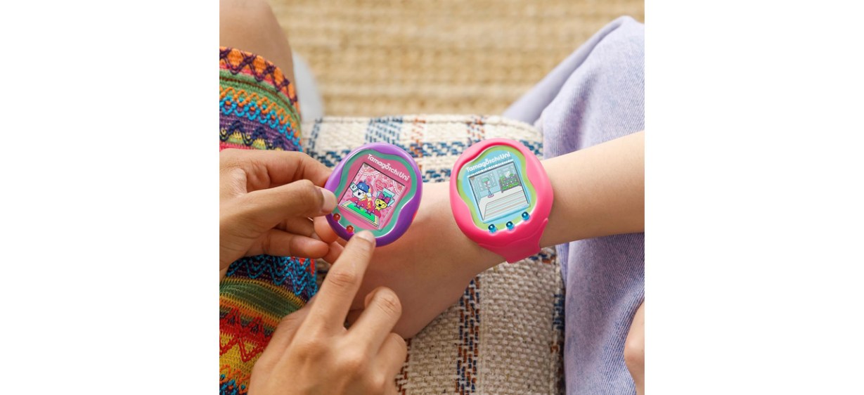 Two children playing with Tamagotchi Uni