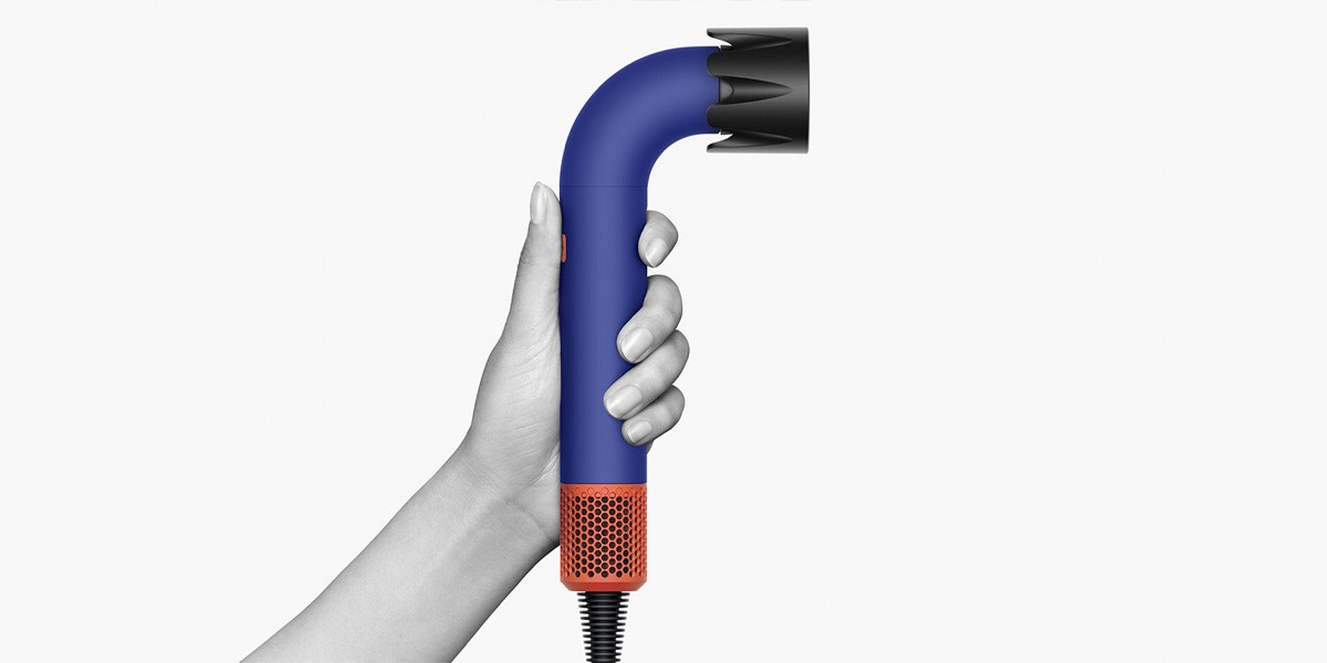 A hand holding the new Dyson hair tool