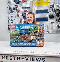 a woman holding a box of Lego